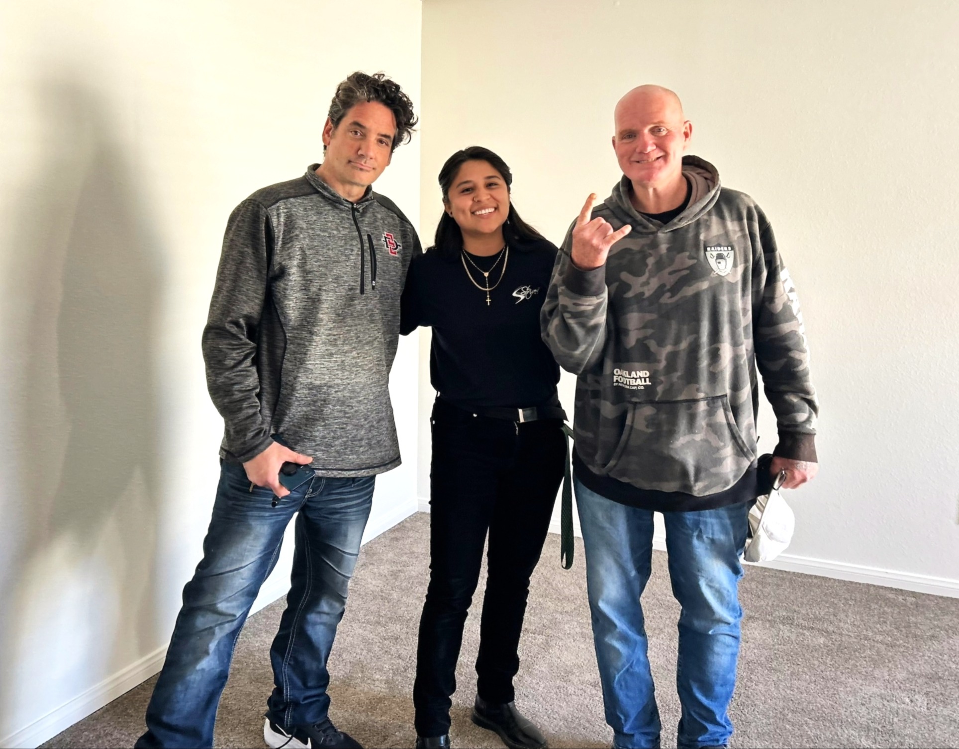 Three people posing for a photo together